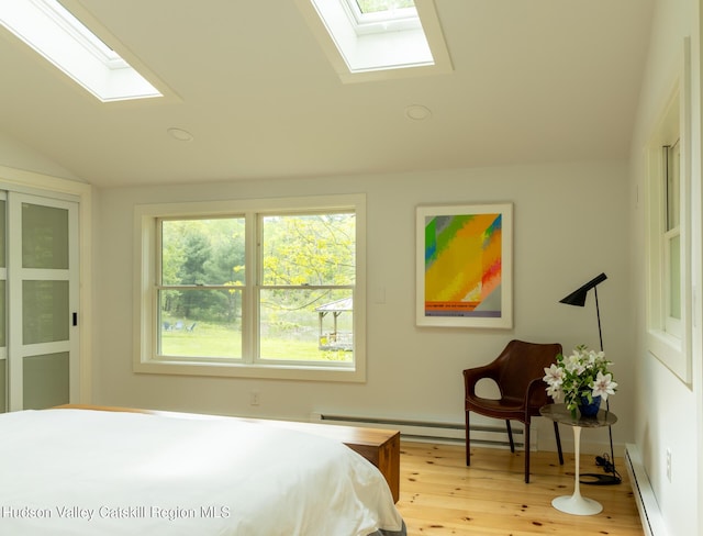 35 Jilroy Ln, Spencertown, NY 12165 - bedroom with a skylight, a baseboard radiator, lofted ceiling, a baseboard heating unit, and wood finished floors