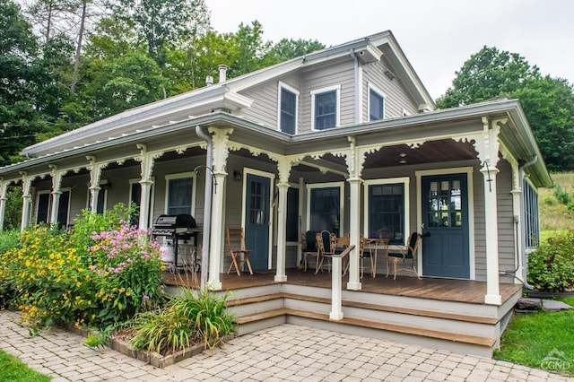 rear view of house featuring a porch
