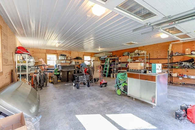 garage with a workshop area and wooden walls