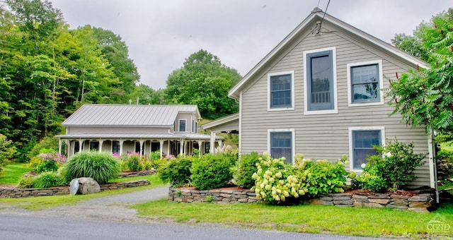 back of property with covered porch