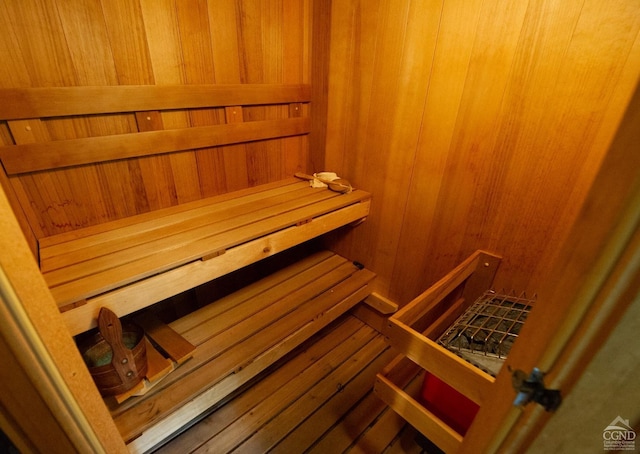 relaxing sauna / steam room featuring wood walls