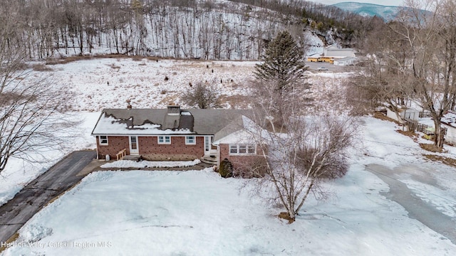 snowy aerial view with a mountain view