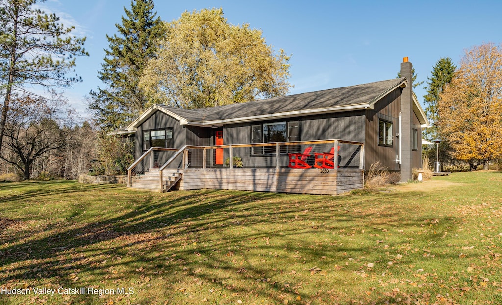 back of property featuring a yard