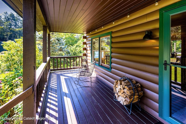 wooden terrace featuring covered porch