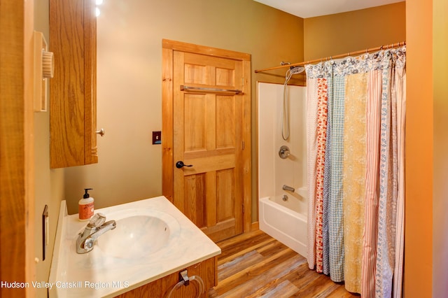 bathroom with shower / bath combo with shower curtain, wood-type flooring, and vanity