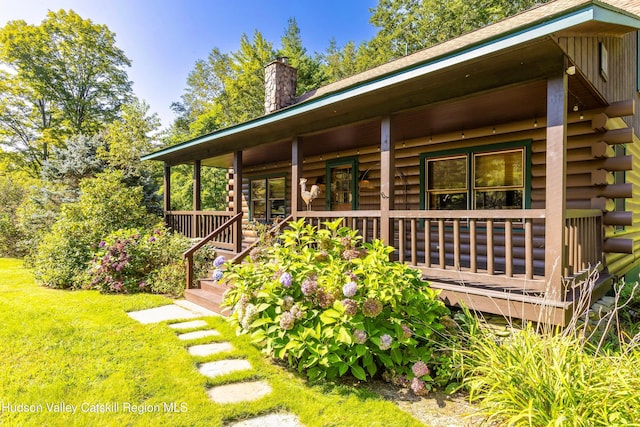 rear view of house featuring a porch