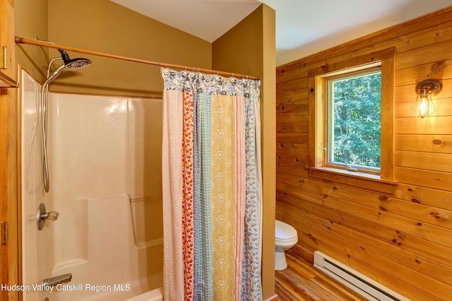 bathroom featuring wood walls, wood-type flooring, baseboard heating, and vaulted ceiling