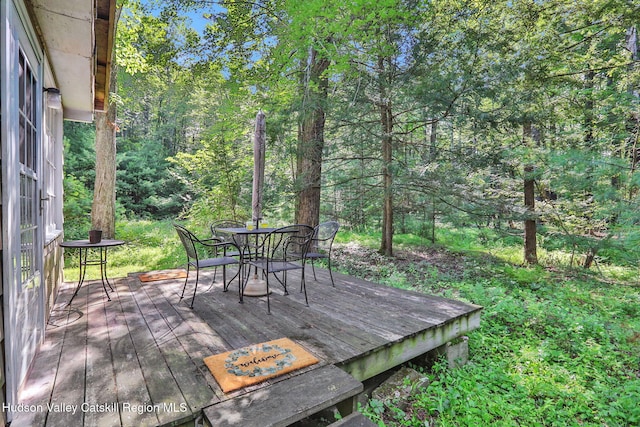 1055 Rte 212, Saugerties, NY 12477 - wooden terrace featuring outdoor dining area and a wooded view
