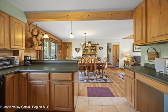 17 Partridge Rd, Hudson, NY 12534 - kitchen with dark countertops, light wood-style floors, a peninsula, a chandelier, and beam ceiling