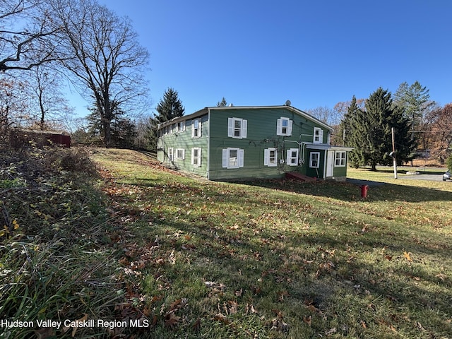 view of side of property with a yard