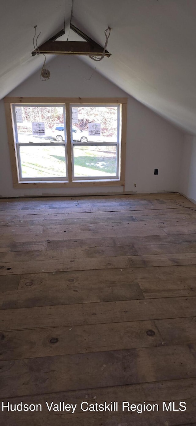 bonus room featuring vaulted ceiling with beams and hardwood / wood-style floors