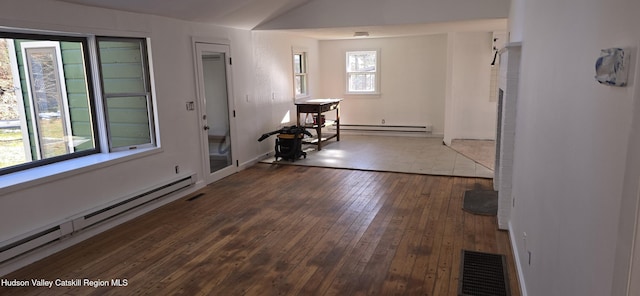 unfurnished room featuring a baseboard radiator and dark hardwood / wood-style floors