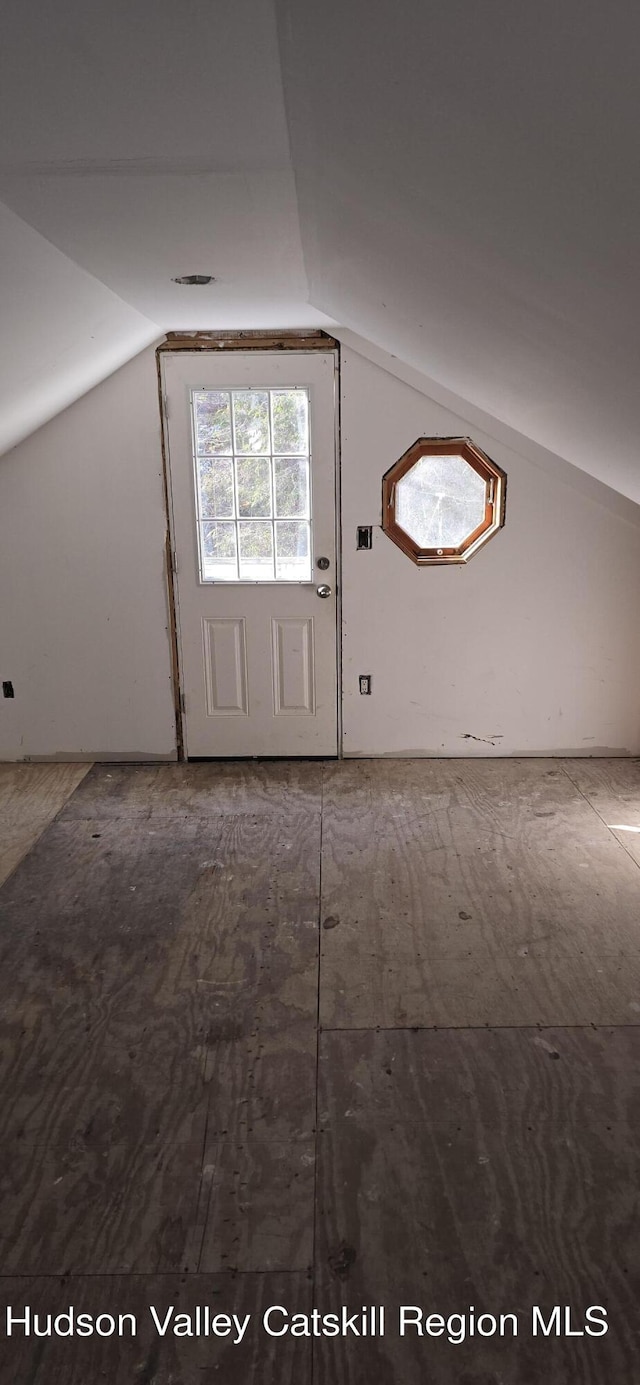 additional living space featuring vaulted ceiling