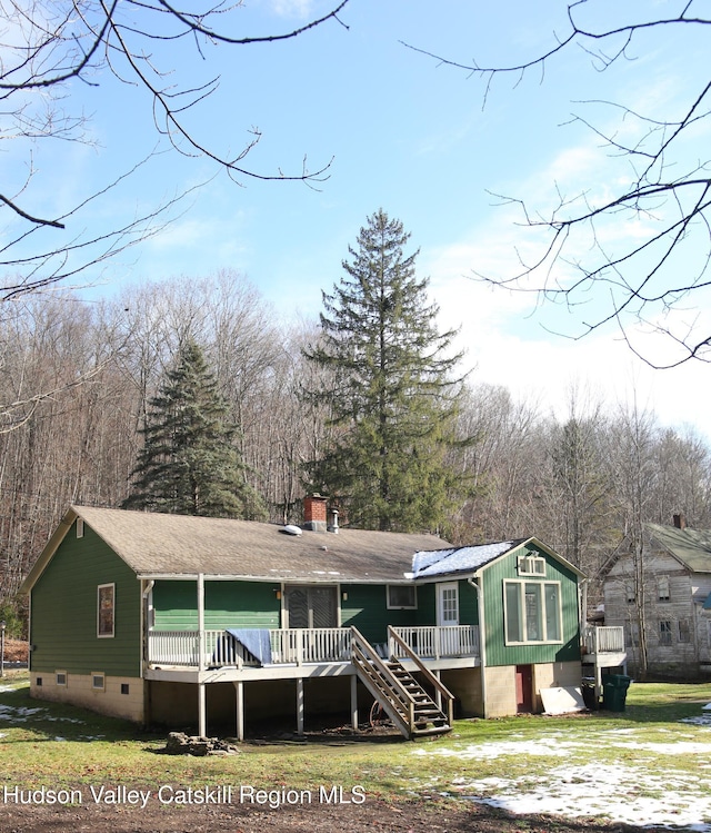 view of front facade with a wooden deck