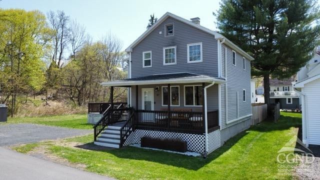 57 Bushnell Ave, Catskill, NY 12414 - view of front of house with a front lawn and a porch