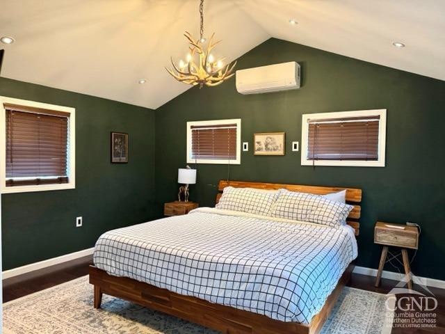57 Bushnell Ave, Catskill, NY 12414 - bedroom with an AC wall unit, vaulted ceiling, a chandelier, wood finished floors, and baseboards