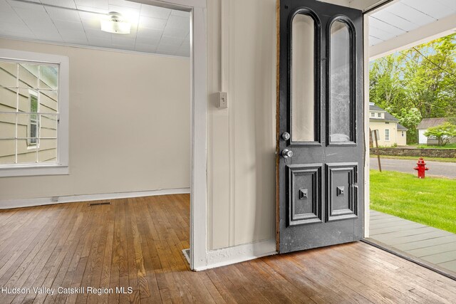 1 Green St, Gilbertsville, NY 13776 - entryway with wood-type flooring, baseboards, and ornamental molding