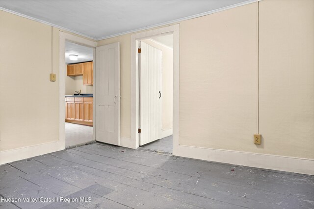 1 Green St, Gilbertsville, NY 13776 - unfurnished bedroom with baseboards, crown molding, and a sink