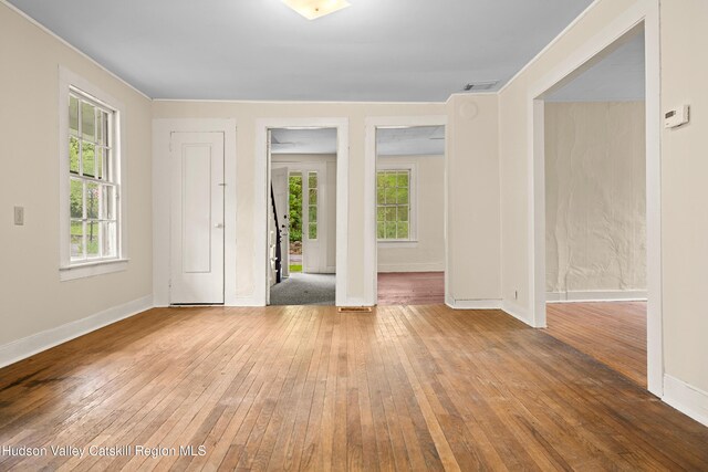 1 Green St, Gilbertsville, NY 13776 - empty room featuring hardwood / wood-style flooring, healthy amount of natural light, and baseboards