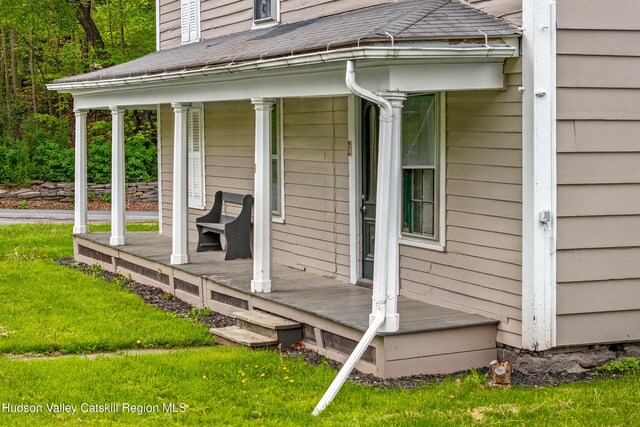 1 Green St, Gilbertsville, NY 13776 - entrance to property with covered porch, a shingled roof, and a yard