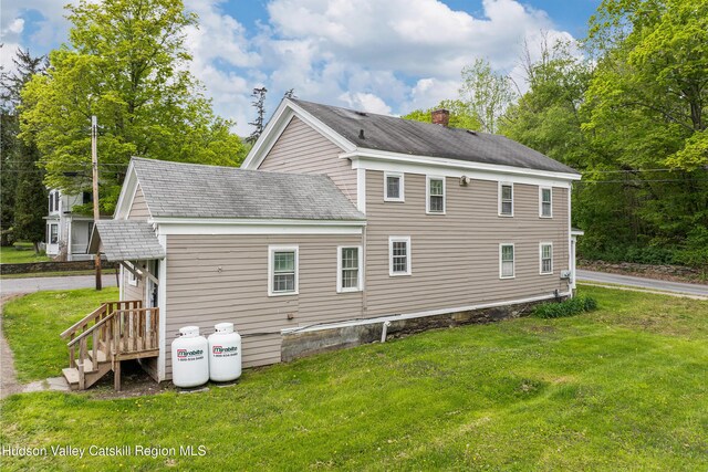 1 Green St, Gilbertsville, NY 13776 - rear view of house featuring a lawn, a shingled roof, and a chimney