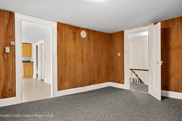 1 Green St, Gilbertsville, NY 13776 - carpeted empty room with wood walls