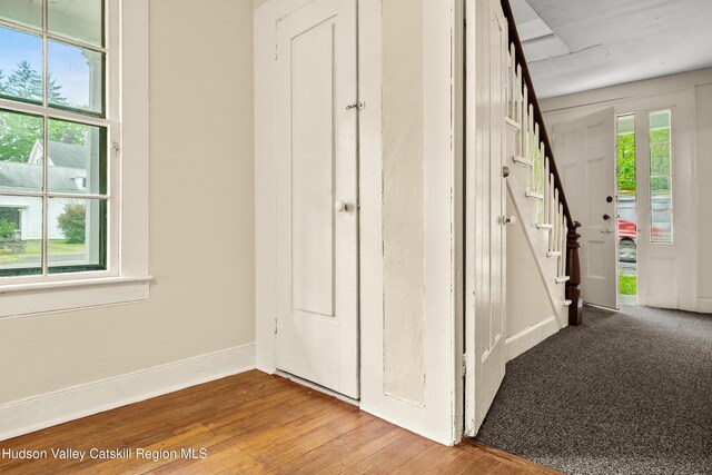 1 Green St, Gilbertsville, NY 13776 - foyer entrance featuring wood finished floors, baseboards, and stairway