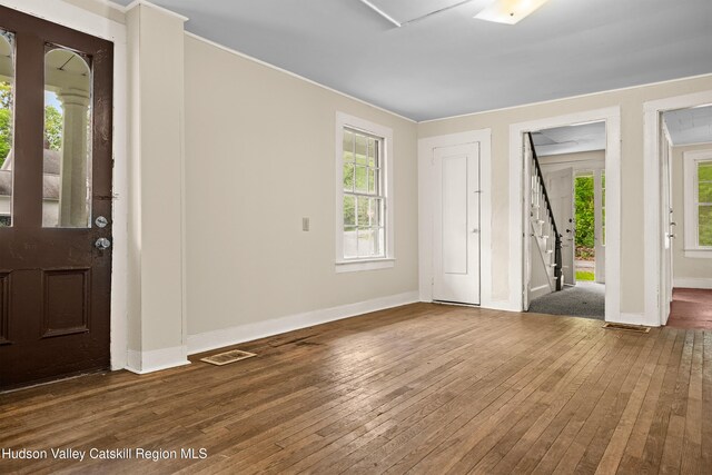 1 Green St, Gilbertsville, NY 13776 - entryway featuring hardwood / wood-style floors, baseboards, stairway, healthy amount of natural light, and crown molding