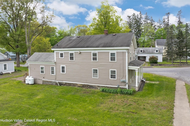 1 Green St, Gilbertsville, NY 13776 - view of property exterior featuring a chimney, a lawn, and roof with shingles
