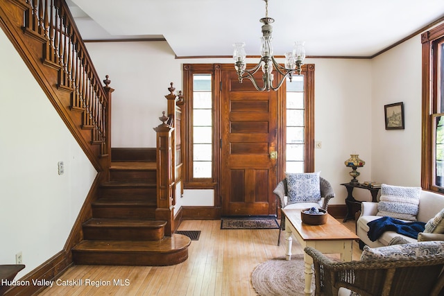 121 Birch Creek Rd, Pine Hill, NY 12465 - entrance foyer with a chandelier, stairs, hardwood / wood-style flooring, healthy amount of natural light, and crown molding