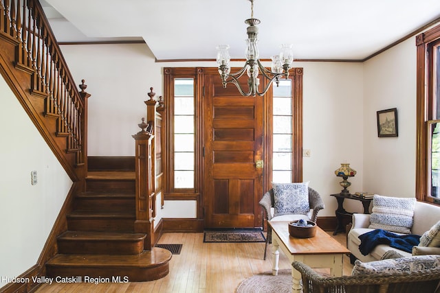 121 Birch Creek Rd, Pine Hill, NY 12465 - foyer entrance featuring a chandelier, stairway, hardwood / wood-style floors, plenty of natural light, and crown molding
