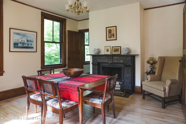 121 Birch Creek Rd, Pine Hill, NY 12465 - dining room with a chandelier, a fireplace with flush hearth, light wood finished floors, and ornamental molding