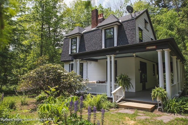 121 Birch Creek Rd, Pine Hill, NY 12465 - view of front of house with a shingled roof, a porch, and a chimney