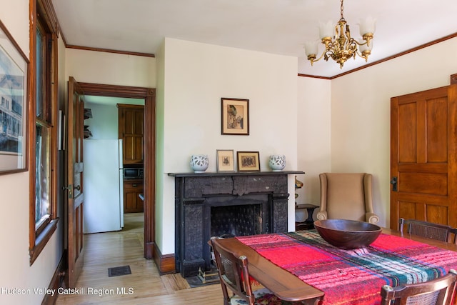 121 Birch Creek Rd, Pine Hill, NY 12465 - dining space with a chandelier, wood finished floors, a fireplace, and crown molding