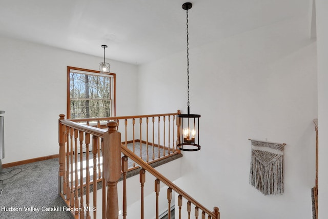 staircase featuring carpet flooring and baseboards