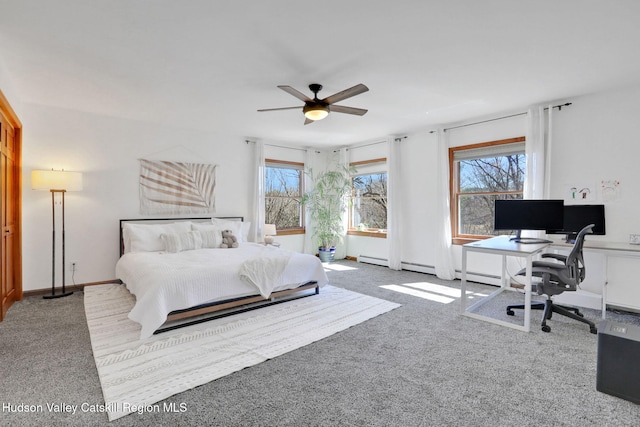 carpeted bedroom with a baseboard radiator and a ceiling fan
