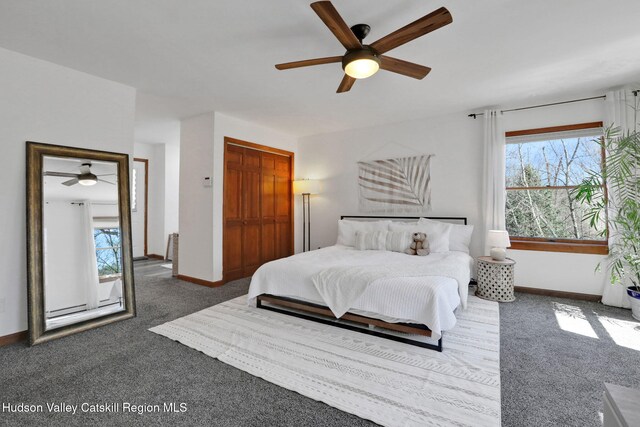 carpeted bedroom featuring baseboards and ceiling fan