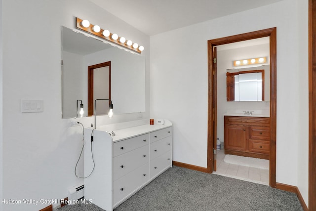 full bath featuring baseboards, vanity, and a baseboard radiator