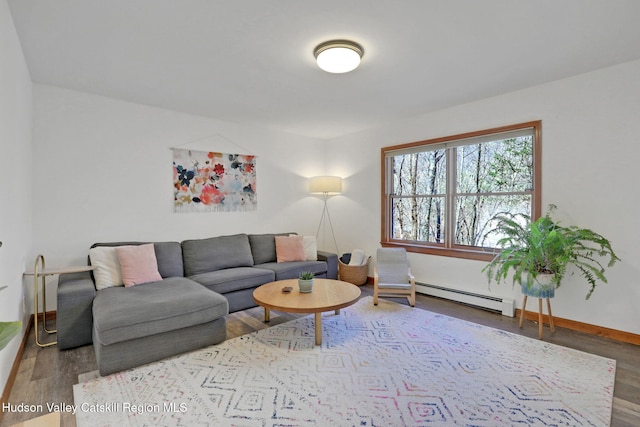 living area featuring baseboards, wood finished floors, and baseboard heating