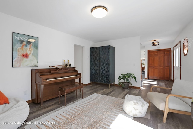 sitting room featuring baseboards and wood finished floors