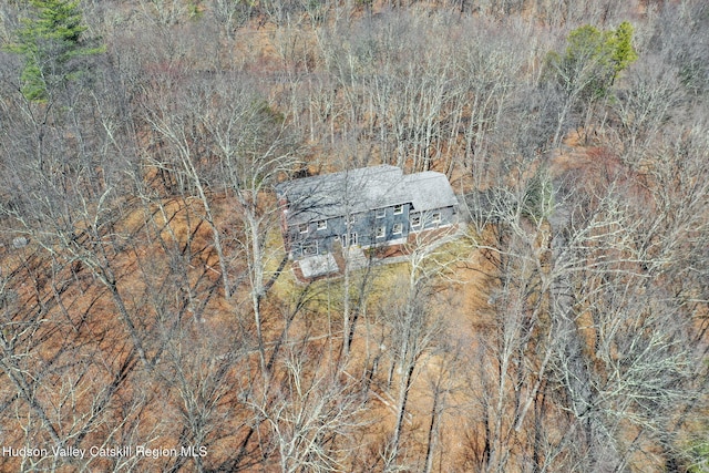 birds eye view of property with a view of trees