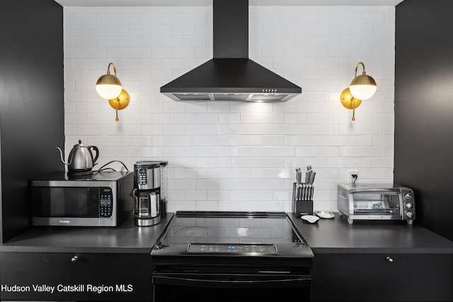 2064 County Highway 8, Denver, NY 12421 - kitchen featuring wall chimney exhaust hood, stainless steel microwave, electric range, tasteful backsplash, and dark countertops