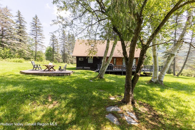 2064 County Highway 8, Denver, NY 12421 - view of green lawn with a wooden deck