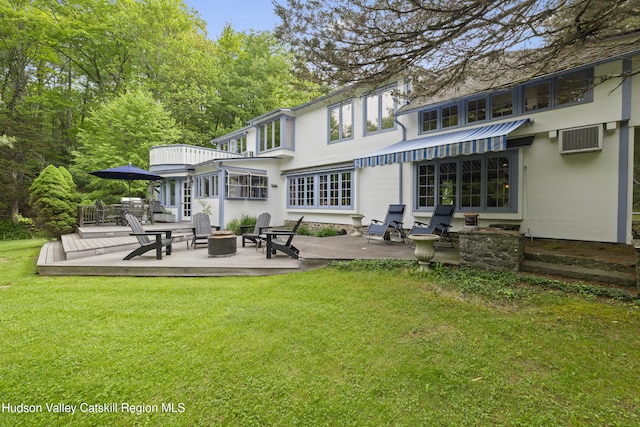 253 Upper Byrdcliffe Rd, Woodstock, NY 12498 - rear view of house featuring a yard, an outdoor fire pit, a wooden deck, a patio, and a wall mounted air conditioner