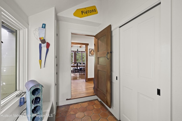 253 Upper Byrdcliffe Rd, Woodstock, NY 12498 - hall with dark tile patterned floors and baseboards