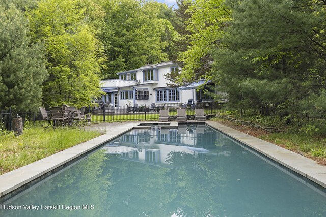 253 Upper Byrdcliffe Rd, Woodstock, NY 12498 - back of property with an outdoor pool and a view of trees