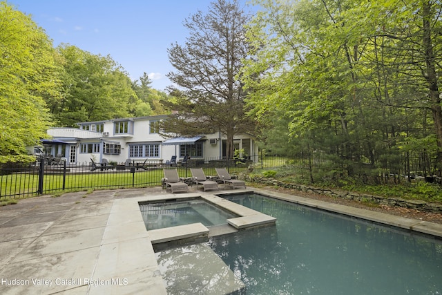 253 Upper Byrdcliffe Rd, Woodstock, NY 12498 - view of swimming pool featuring a patio, a pool with connected hot tub, and a view of trees