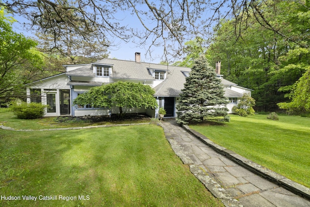 253 Upper Byrdcliffe Rd, Woodstock, NY 12498 - view of front of house featuring a chimney, a front lawn, and roof with shingles