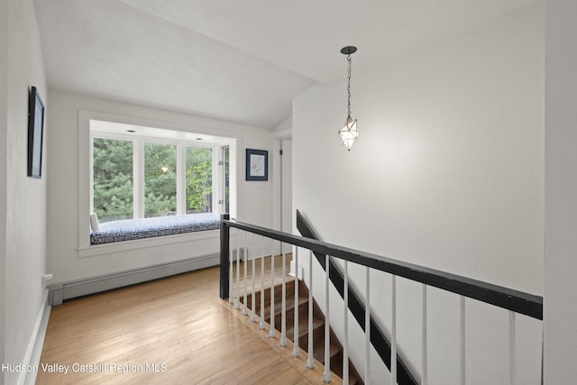 253 Upper Byrdcliffe Rd, Woodstock, NY 12498 - stairs featuring a baseboard radiator, wood finished floors, lofted ceiling, and baseboards