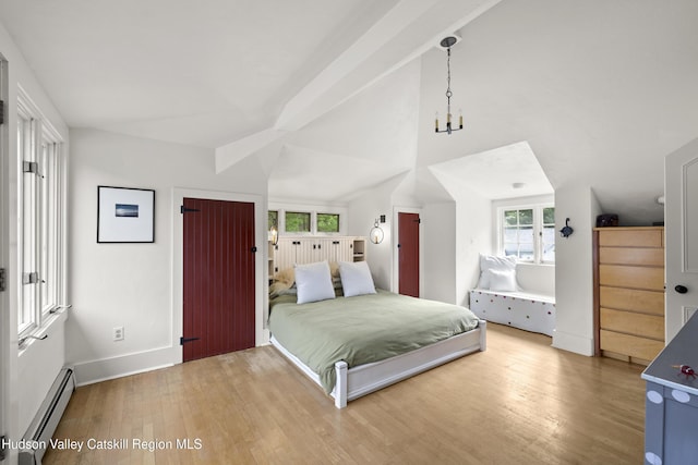 253 Upper Byrdcliffe Rd, Woodstock, NY 12498 - bedroom with baseboard heating, wood finished floors, lofted ceiling, and baseboards